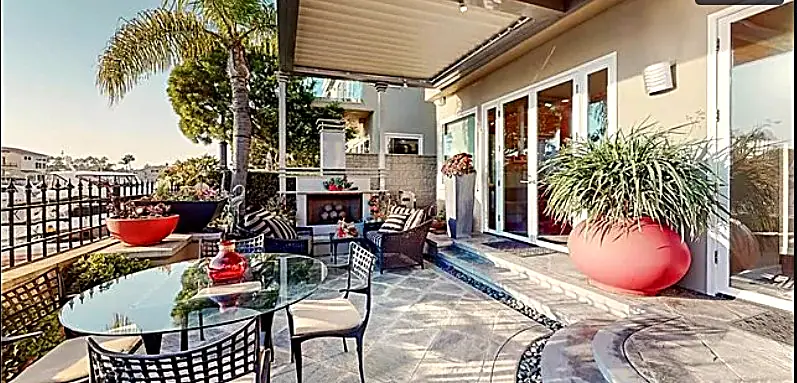 Outdoor terrace with dining area, fireplace, and harbor views — Long Beach, CA