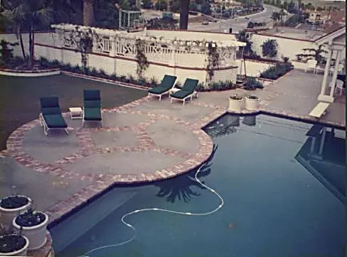 Resort-style pool with brick coping and expansive patio